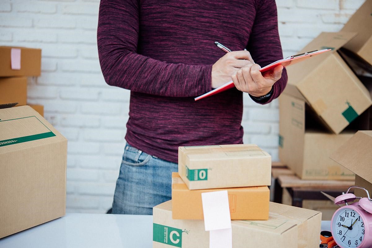 Man checking his product logistics before delivery to customers.